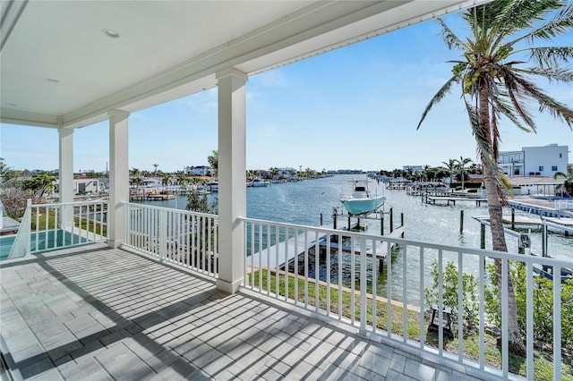 wooden deck featuring a dock and a water view