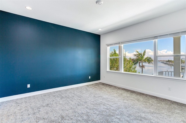 empty room featuring carpet floors and a water view