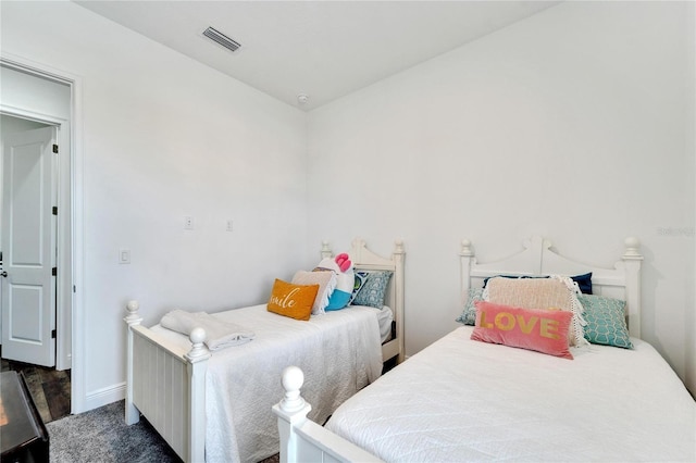 bedroom with dark colored carpet