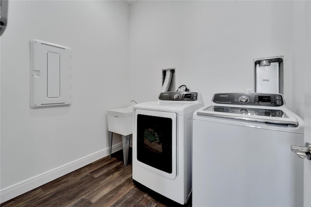 laundry room featuring dark hardwood / wood-style flooring, electric panel, and washer and clothes dryer