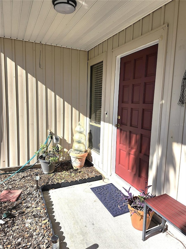 view of exterior entry with a patio