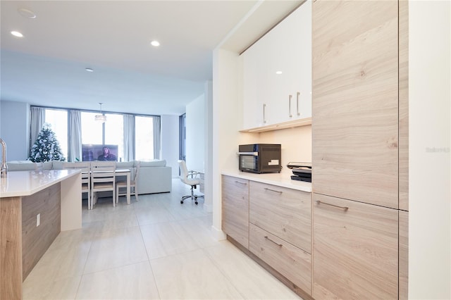 kitchen with light tile patterned flooring and hanging light fixtures