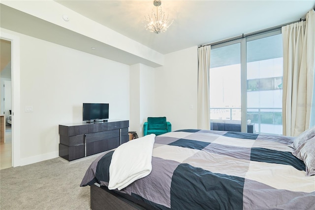 bedroom with a notable chandelier, light colored carpet, a wall of windows, and multiple windows