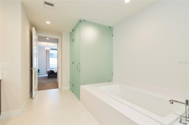 bathroom featuring a washtub and vanity