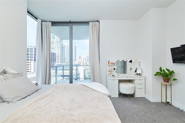 carpeted bedroom featuring floor to ceiling windows and access to outside