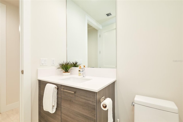 bathroom with tile patterned floors, vanity, and toilet