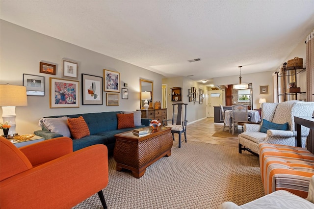 tiled living room featuring a textured ceiling