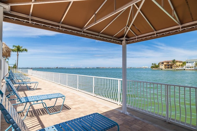 view of patio featuring a gazebo and a water view