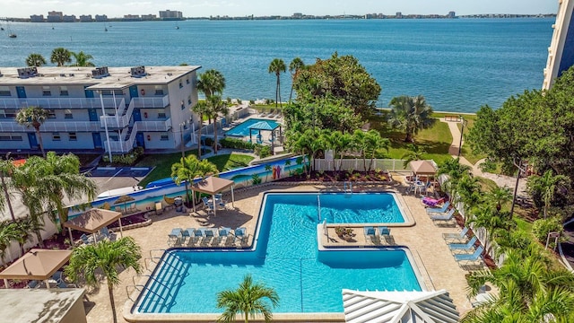 view of swimming pool featuring a patio area and a water view