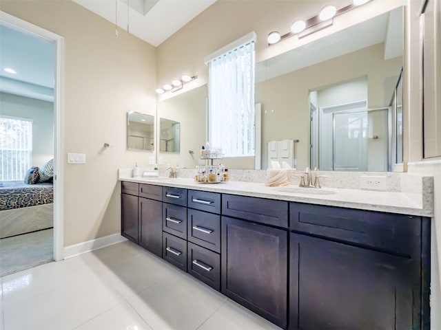 bathroom with tile patterned flooring, vanity, and a shower with door