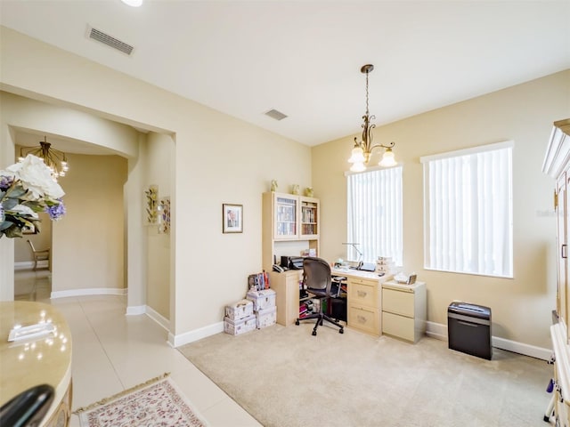 office space with light colored carpet and a notable chandelier