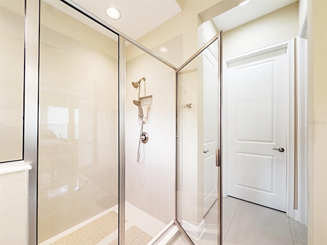 bathroom with tile patterned floors and walk in shower