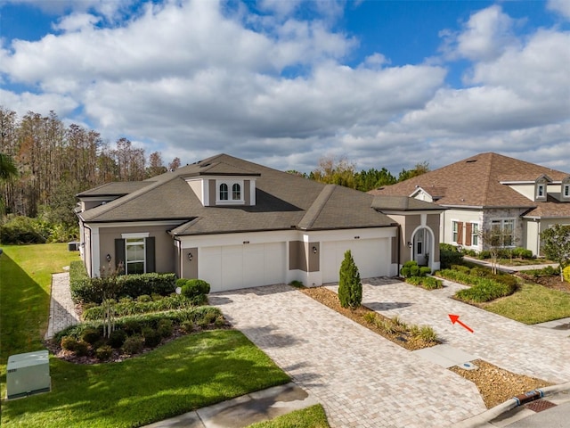 view of front of home with a front yard and a garage