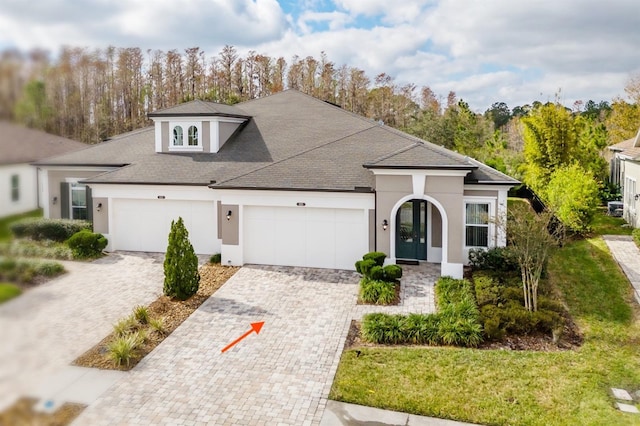 view of front of house featuring a front yard and a garage