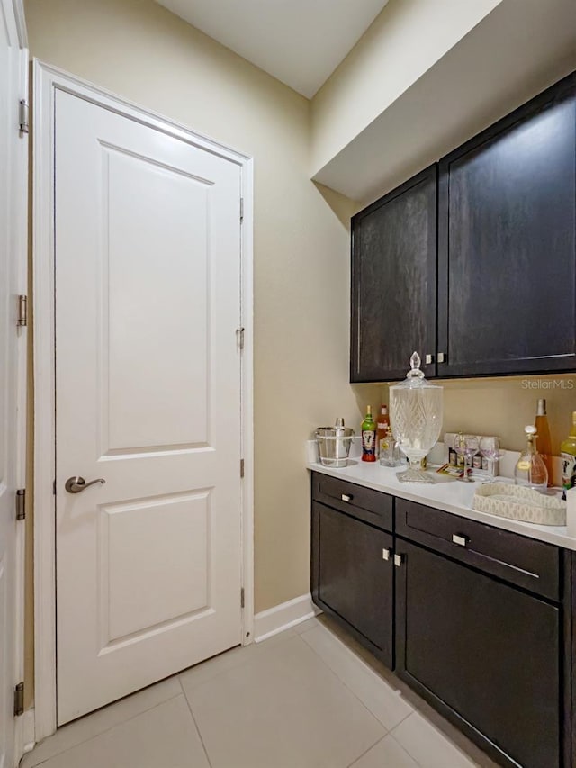 kitchen featuring dark brown cabinets and light tile patterned floors