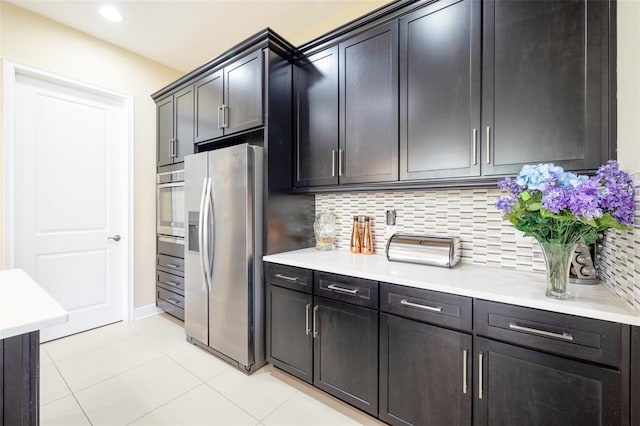 kitchen featuring light tile patterned floors, stainless steel appliances, and tasteful backsplash