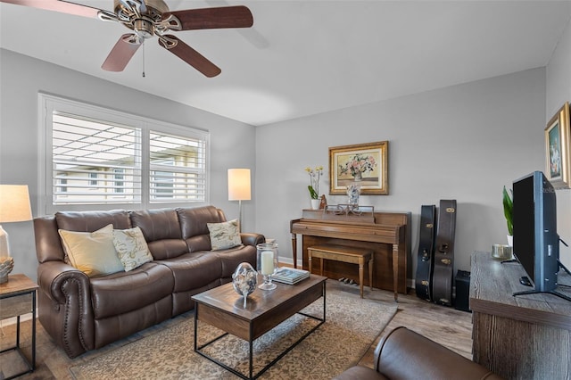 living room with ceiling fan and light wood-type flooring