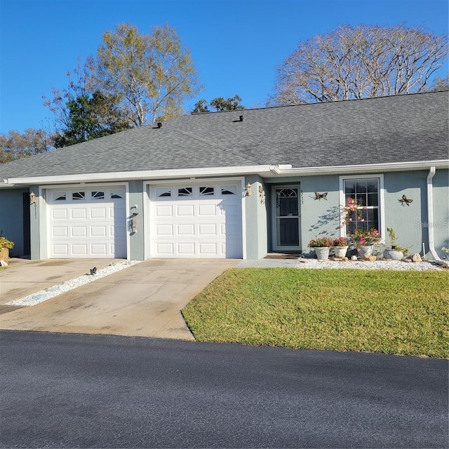 single story home featuring a garage and a front yard