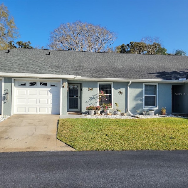 ranch-style house with a garage and a front lawn