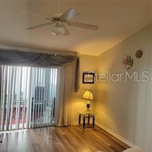 spare room with ceiling fan and wood-type flooring