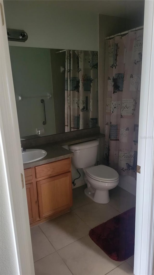 bathroom featuring tile patterned flooring, vanity, and toilet