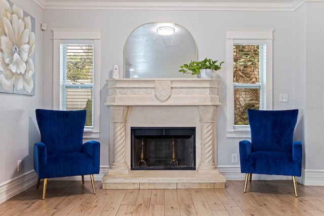 living area with wood-type flooring and ornamental molding