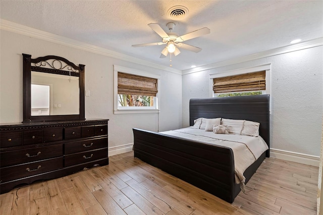 bedroom with crown molding, a textured ceiling, ceiling fan, and light hardwood / wood-style flooring