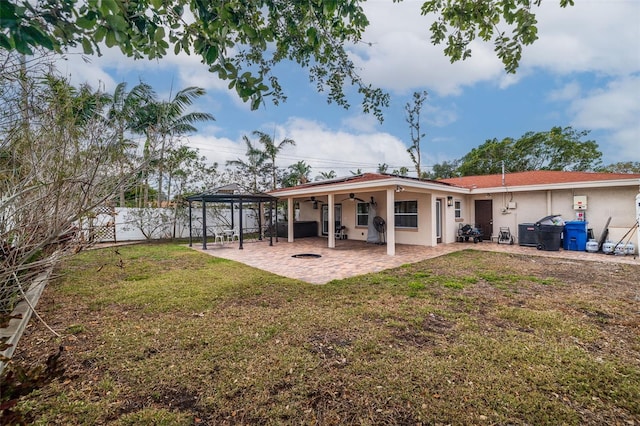 rear view of house with a gazebo, a yard, and a patio