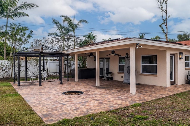 view of patio featuring a gazebo, a hot tub, and ceiling fan