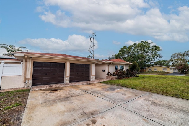 ranch-style home featuring a garage and a front yard