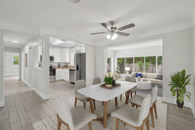 dining area featuring ceiling fan and light hardwood / wood-style floors