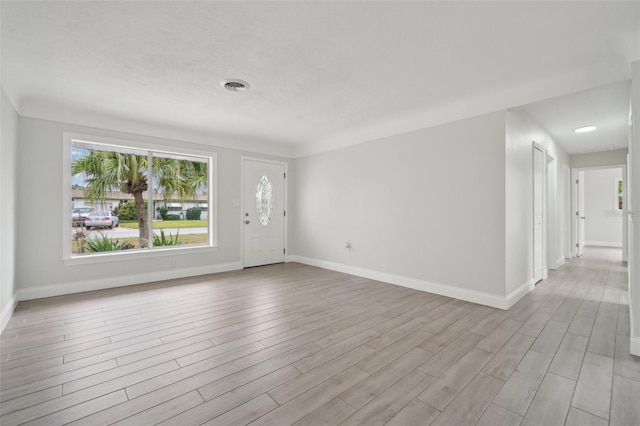 unfurnished room with light hardwood / wood-style floors