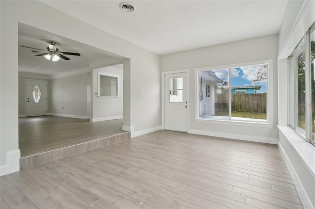 interior space with plenty of natural light, ceiling fan, and light hardwood / wood-style flooring