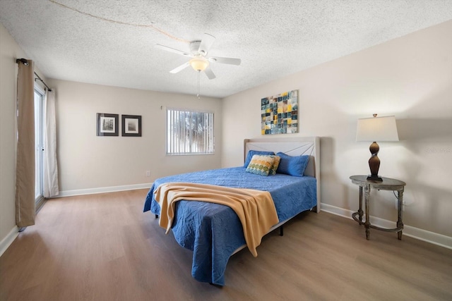 bedroom featuring hardwood / wood-style flooring, ceiling fan, and a textured ceiling