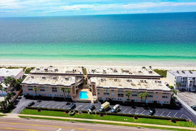 drone / aerial view featuring a water view and a beach view