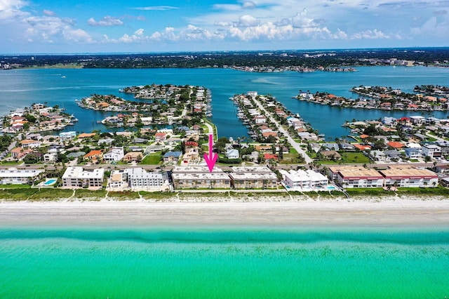 birds eye view of property featuring a water view and a beach view