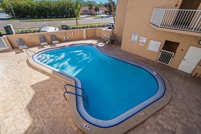 view of swimming pool with a patio