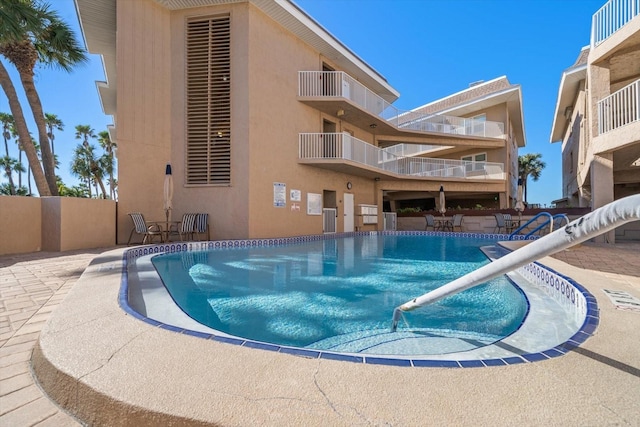 view of swimming pool with a patio area