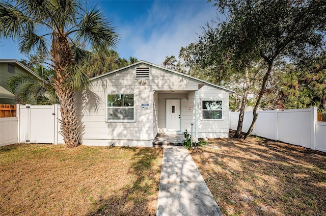 bungalow-style home with a front lawn