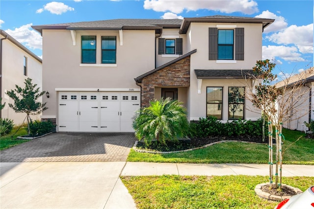 view of front of home featuring a front yard and a garage