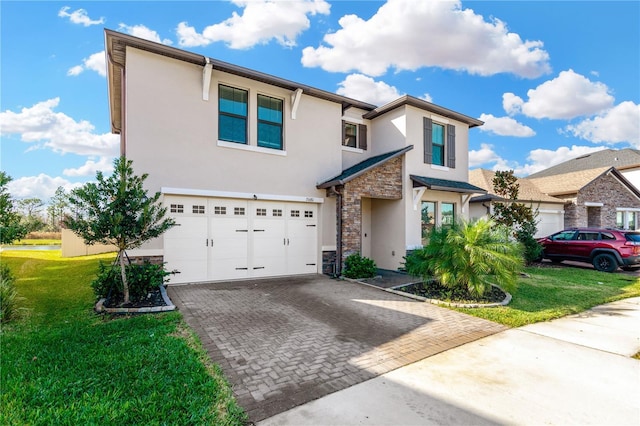 view of property featuring a front yard and a garage