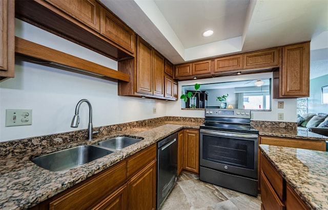 kitchen with stone counters, dishwasher, sink, a raised ceiling, and electric stove