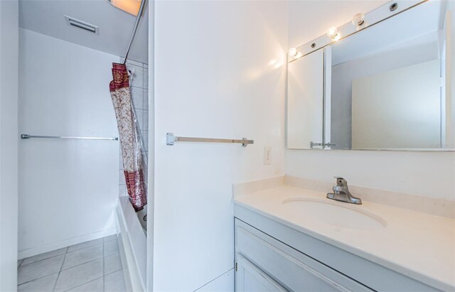 bathroom with shower / bathtub combination with curtain, tile patterned flooring, and vanity