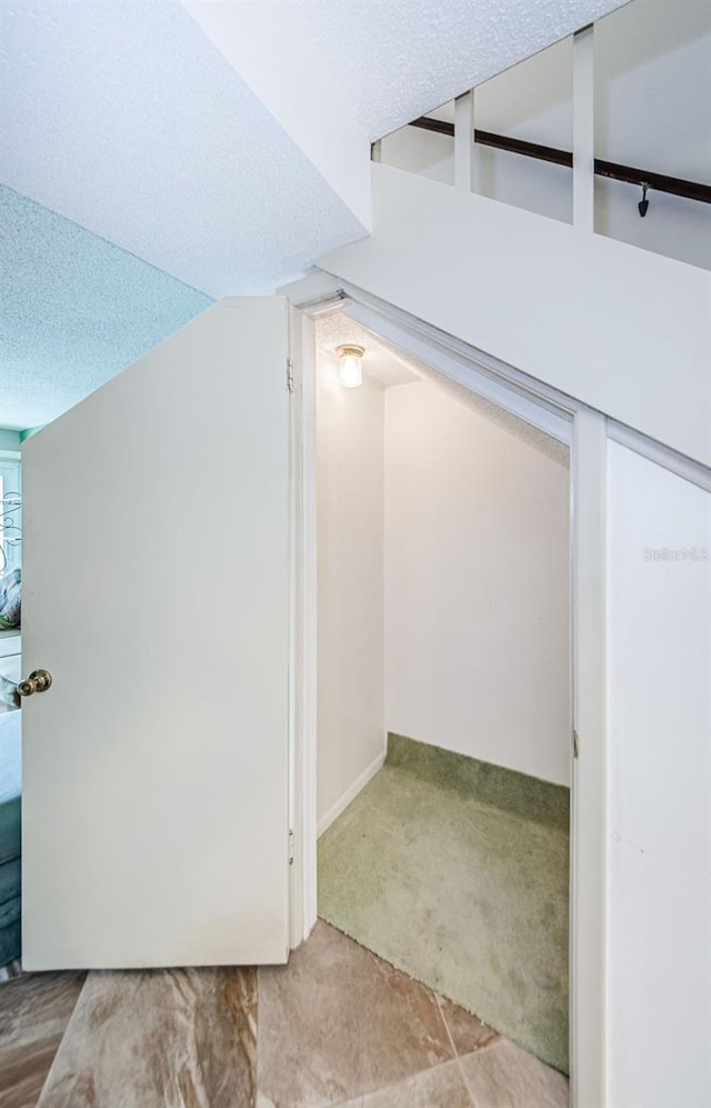 bonus room featuring carpet, a textured ceiling, and vaulted ceiling