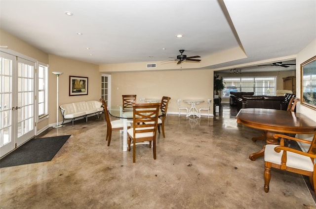 dining room with concrete flooring, french doors, and ceiling fan