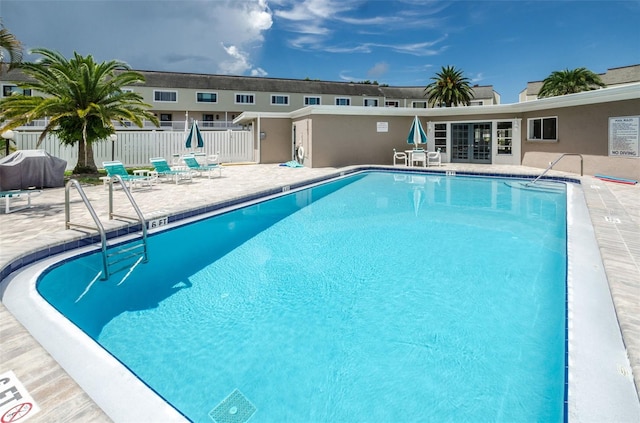 view of swimming pool with a grill and a patio area