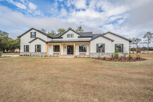 modern inspired farmhouse with covered porch and a front yard