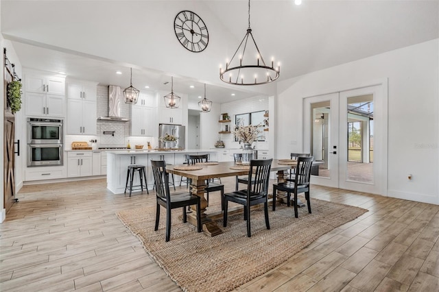 dining area with a notable chandelier and french doors