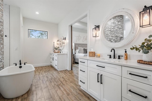 bathroom featuring a bathing tub and vanity