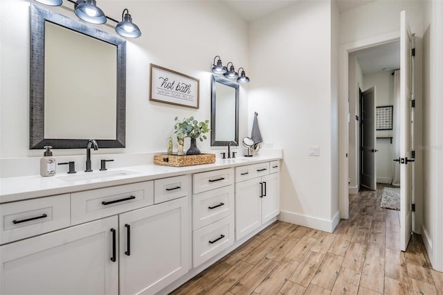 bathroom with vanity and wood-type flooring